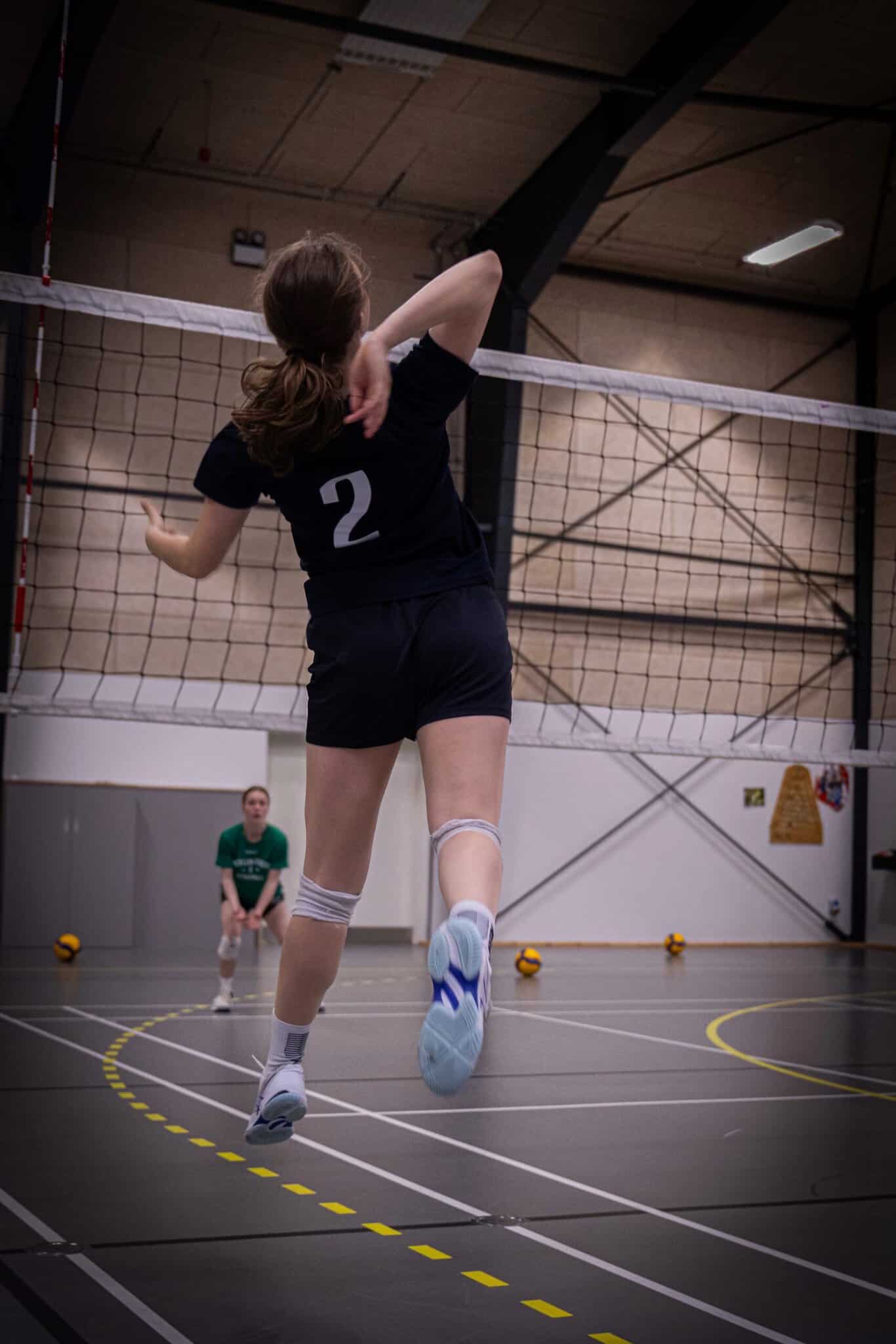 En svævende pige midt i en smashøvelse på linjefaget Volleyball på Nøvlingskov Efterskole